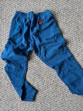 Nike Kids Navy Blue Joggers with Orange Swoosh